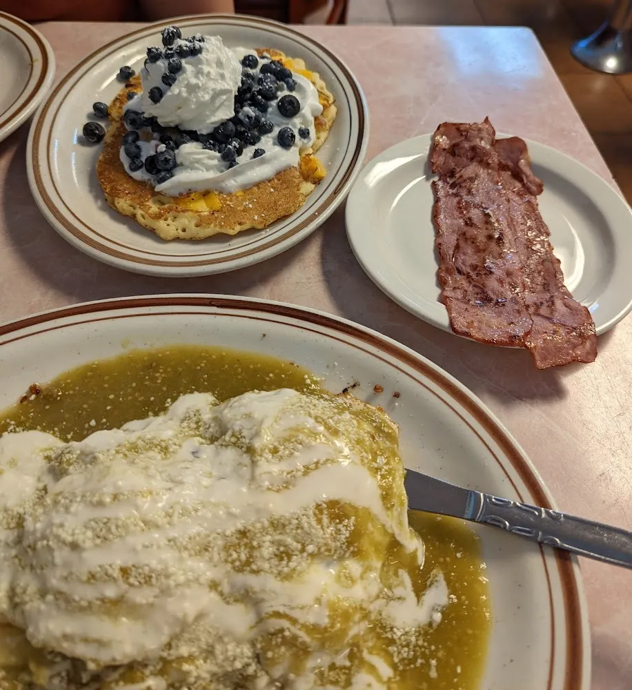 Huevos Campesinos with Turkey Bacon and Pumpkin Pancakes Topped with Blue Berries and Whipped Cream